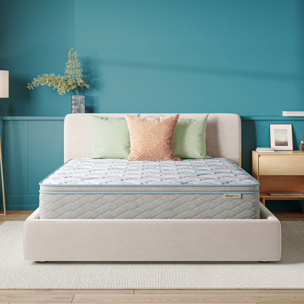 Beautysleep Mattress in a grey bedframe with 3 pillows on top of it within a bedroom setting