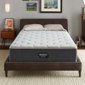 The Beautyrest Silver BRS900 Plush mattress in a bedroom on a brown bed