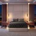 Modern bedroom with a cream bed frame featuring a Beautyrest Black Hybid XCS mattress, nightstands, and decorative elements.